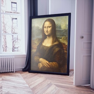 May include: A framed painting of the Mona Lisa, a famous portrait by Leonardo da Vinci. The painting is in a black frame and the woman in the painting is wearing a dark dress and has a soft smile.