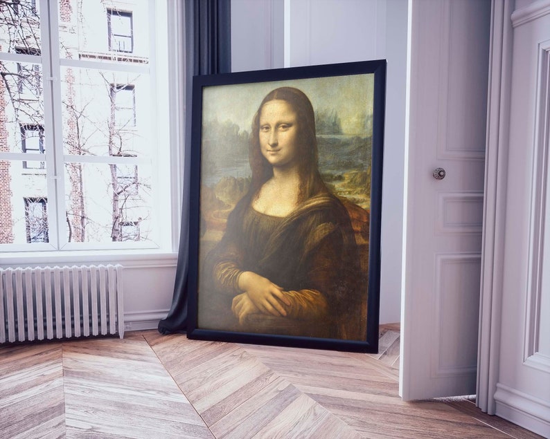May include: A framed painting of the Mona Lisa, a famous portrait by Leonardo da Vinci. The painting is in a black frame and the woman in the painting is wearing a dark dress and has a soft smile.