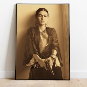 May include: A black and white portrait of a woman with dark hair, wearing a dark robe and a necklace. She is holding a gun in her right hand.