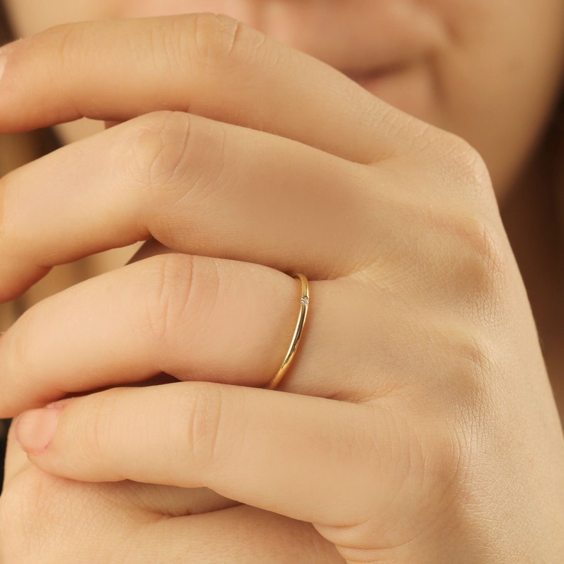 Side view showing ultra-slim 1.20mm band profile, 8K solid gold single diamond ring with delicate minimalist design