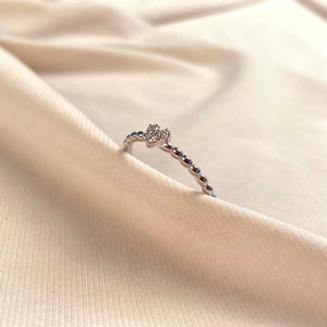 Side view of beaded bubble band profile showing round bead texture detail, 14K solid gold heart diamond stackable ring