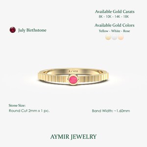 Close-up of bezel-set 2.00mm lab-grown ruby on slim 1.60mm fluted ribbed gold band, July birthstone detail