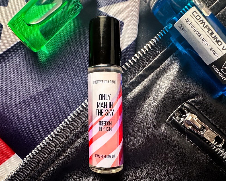 May include: A small glass bottle of perfume oil with a red, white, and blue striped label. The label reads "Pretty Witch Craft", "Only Man in the Sky", "Freedom Heroism", and "10ml Perfume Oil".