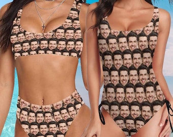 May include: Two women wearing swimsuits with a pattern of a man's face repeated all over the fabric. The swimsuit on the left is a bikini top and bottom, while the swimsuit on the right is a one-piece.