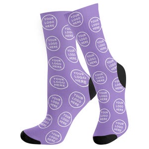 May include: A pair of purple socks with a white circle pattern. Each circle contains the text "YOUR LOGO HERE".