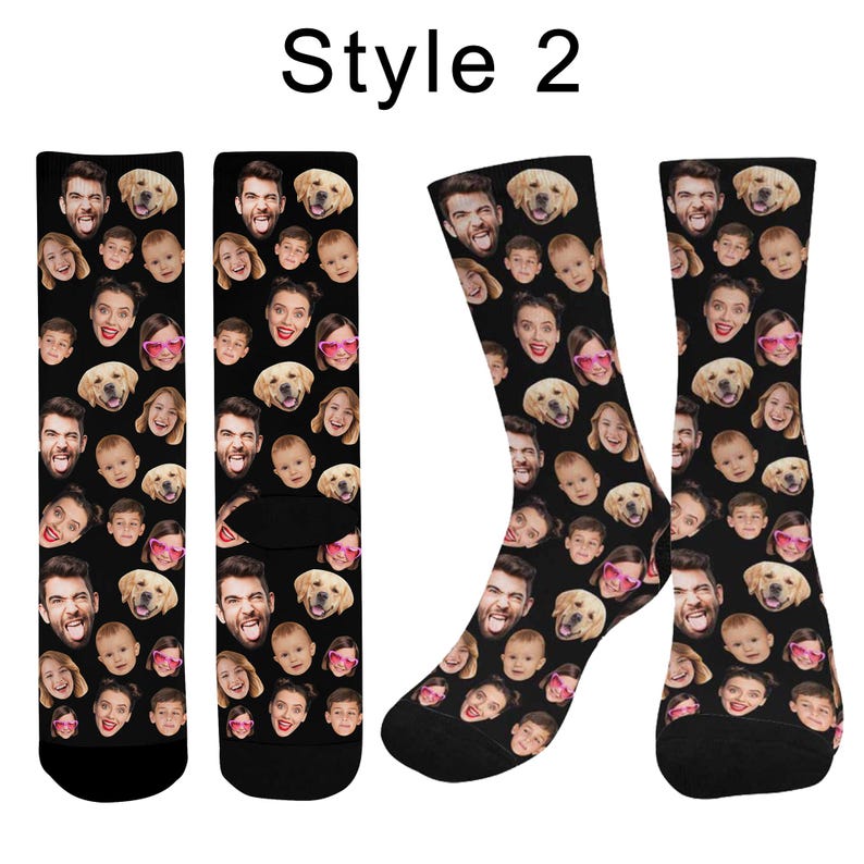 May include: A pair of black crew socks featuring a repeating pattern of various human faces and a golden retriever dog face. The text "Style 2" is printed in black at the top center of the image above the socks.