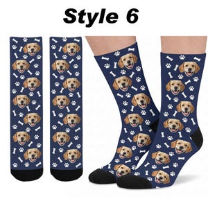 May include: A pair of navy blue crew socks featuring a repeating pattern of a golden retriever's face, white paw prints, and white bones. The text "Style 6" is printed in black at the top of the image. The socks have solid black heels and toes.