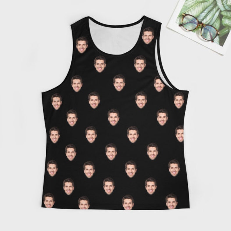 May include: A black tank top with a repeating pattern of a man's face.