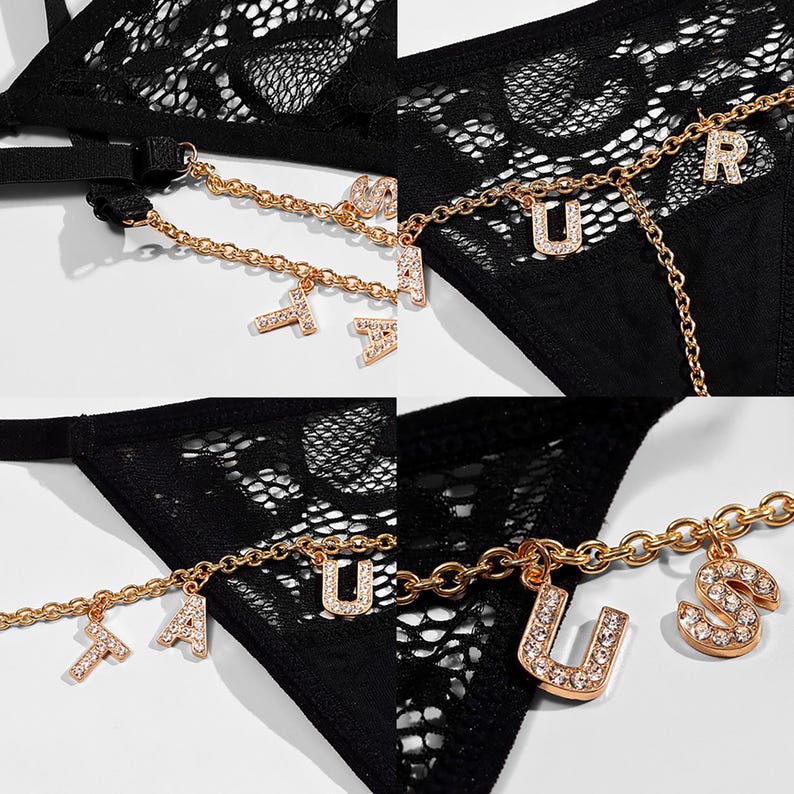 May include: Black lace lingerie with a gold chain and charms that spell out "FAUSTUS".