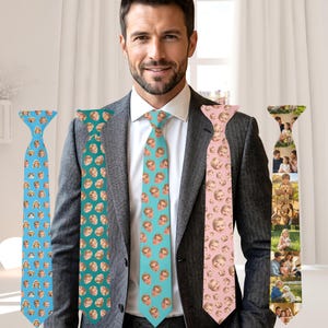 May include: A man in a gray suit wearing a white shirt and several custom ties. The ties are light blue with baby faces, teal with baby faces, light pink with baby faces, and a tie with family photos.