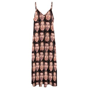 May include: A black sleeveless dress with a repeating pattern of faces. The faces are of a man and a woman, and they are all smiling.