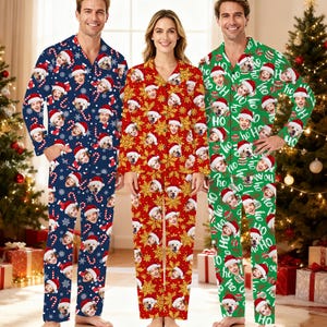 May include: Three sets of Christmas pajamas. One set is navy blue with Santa hats, faces, candy canes, and snowflakes. The second set is red with gold snowflakes and faces. The third set is green with Santa hats, faces, and the word "HO".