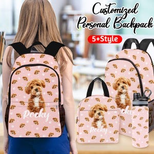 May include: A pink backpack, lunch bag, and water bottle set featuring a brown puppy and paw prints. The backpack has black straps and a mesh side pocket. The name "Rocky" is printed on the backpack and lunch bag.