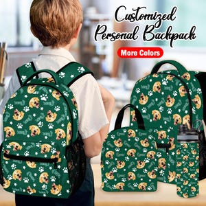 May include: A green backpack, lunch bag, and water bottle set featuring a pattern of golden retriever faces, white paw prints, and the name "Lucas". The backpack is on a child. Text reads "Customised Personal Backpack" and "More Colours".