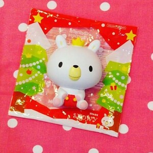 May include: A white plush toy bear wearing a red and white Christmas outfit and a gold crown. The bear is in a clear plastic bag with a red and green Christmas tree design. The bag has the text "Xmas Snowy" on it.