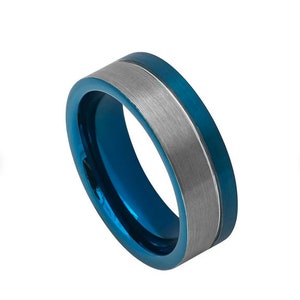 May include: A blue and silver tungsten carbide ring with a brushed finish. The ring has a beveled edge and a flat top.