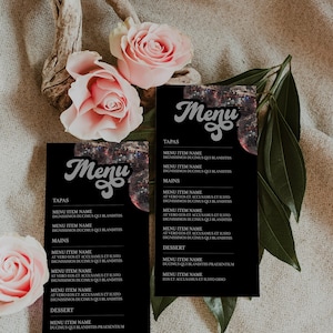 May include: Two black menus with a disco ball design and the word "Menu" in a stylized font. The menus list various food items with the headings "Tapas", "Mains", and "Dessert".