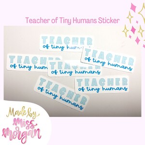 May include: Six blue and white stickers with the text "Teacher of tiny humans" on a white background. The stickers are made by "miss morgan".