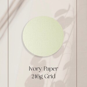 May include: A close-up of a textured ivory paper sample. The paper is a light cream color and has a grid pattern. The text "Ivory Paper 246g Grid" is printed below the sample.