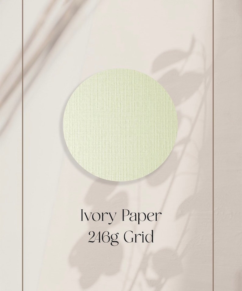 May include: A close-up of a textured ivory paper sample. The paper is a light cream color and has a grid pattern. The text "Ivory Paper 246g Grid" is printed below the sample.