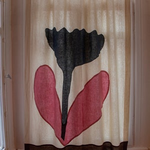 Könnte beinhalten: Ein weißer Leinenvorhang mit einem schwarzen und rosafarbenen Blumendesign. Die Blume hat einen schwarzen Stiel und zwei rosafarbene Blütenblätter.