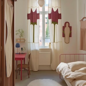 K&ouml;nnte beinhalten: Ein Schlafzimmer mit cremefarbenen Vorh&auml;ngen mit gro&szlig;en kastanienbraunen und gr&uuml;nen Blumenmotiven, einem rosa Schreibtisch mit Holzstuhl, einem rosa Metallbett mit cremefarbener Bettw&auml;sche, einem ovalen cremefarbenen Teppich und einem Holzschrank.
