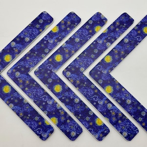May include: Six L-shaped decorative pieces with a print of Van Gogh's "Starry Night" painting. The pieces are dark blue with swirling patterns, yellow stars, and a bright yellow moon.