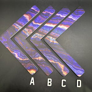 May include: Five L-shaped decorative pieces with a marbled pattern in shades of purple, orange, and black. The letters A, B, C, and D are placed below each piece. The pieces are arranged on a dark surface.