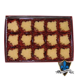 May include: A box of maple leaf-shaped sweets. The light brown candies are presented in individual red paper cups. The box has a red border and a logo in the bottom right corner.