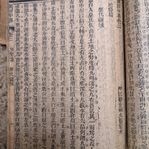 May include: A page from an old book with black text printed on yellowed paper. The text is in Chinese characters and includes the words "歴代疆域" which translates to "Historical Territories".