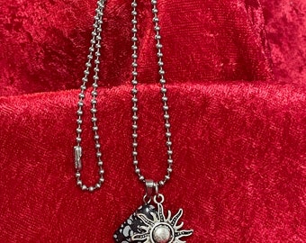 Sun pendant and a snowflake obsidian stone necklace