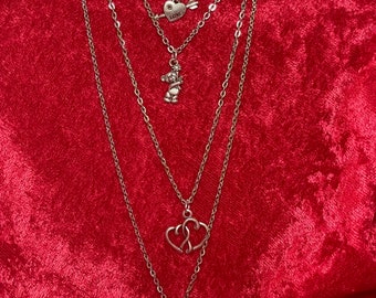 Charm necklace with Key, hearts, teddy bear, and heart with an arrow