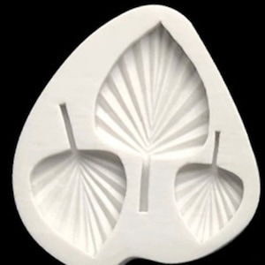 May include: White silicone mould with three leaf shapes. The leaves have a fan-like design.