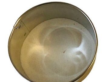 May include: A silver round cake pan with a removable bottom. The pan is empty and ready to be used for baking.