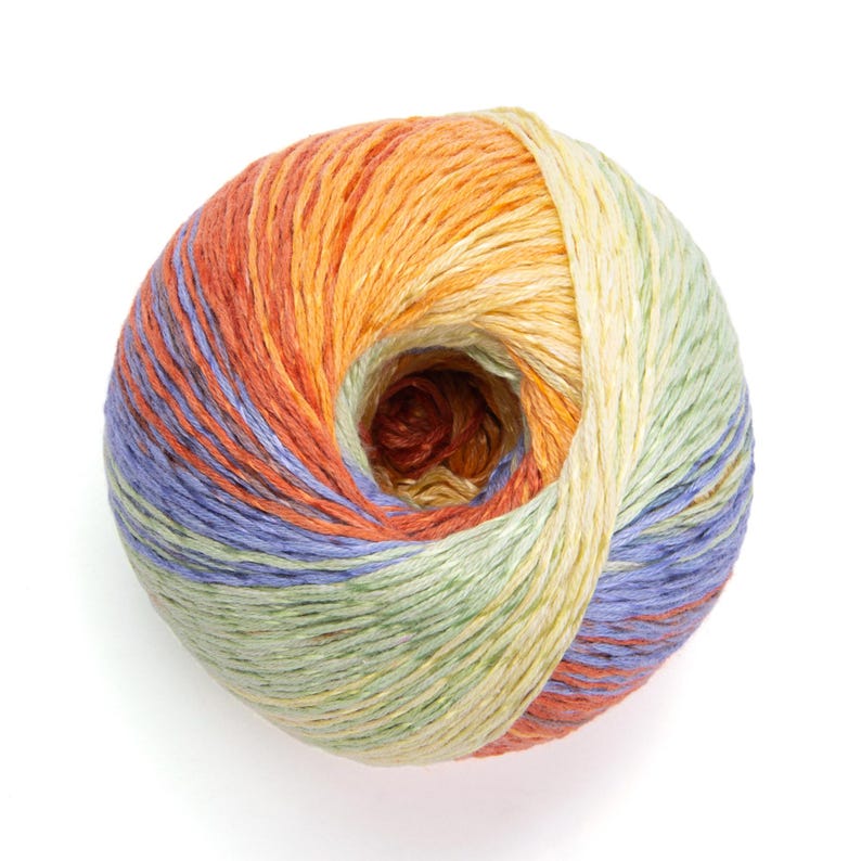 May include: A ball of colorful yarn with a gradient of orange, yellow, green, blue, and red hues. The yarn is tightly wound, revealing a central hole. Ideal for knitting, crocheting, and other fiber arts projects.