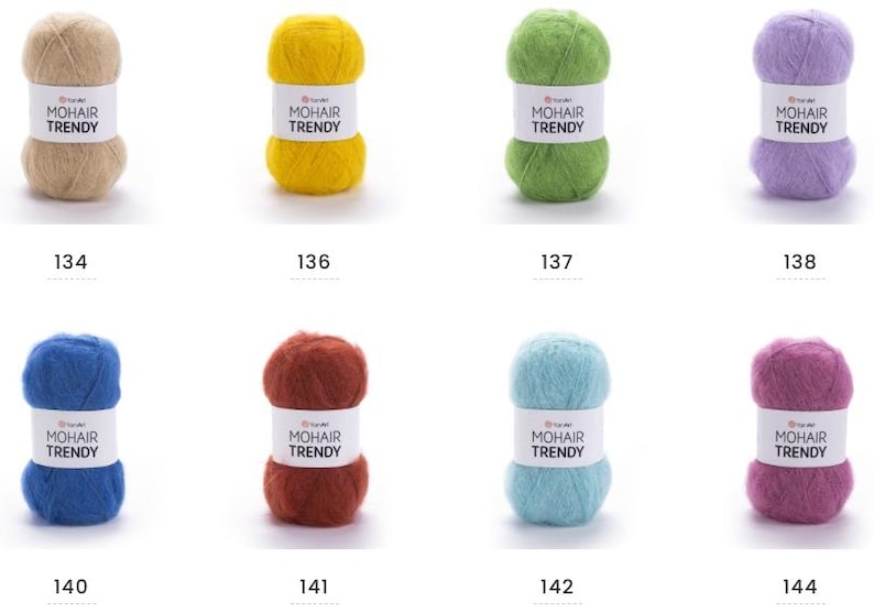 May include: Eight balls of mohair yarn in various colours: beige, yellow, green, purple, blue, red, light blue, and pink. Each ball has a white label with "MOHAIR TRENDY" and a number below.