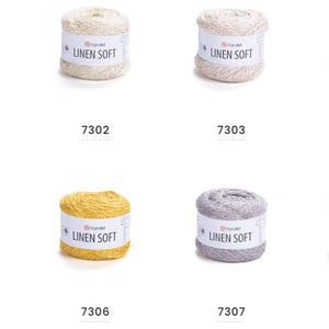 May include: A collection of eight spools of yarn in various colors, including white, beige, light gray, and brown. Each spool has a label that reads "LINEN SOFT" and a unique number.