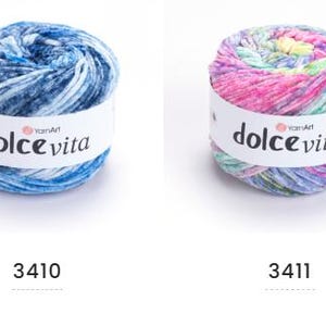 May include: Four skeins of Dolce Vita yarn in various colors. The skeins are labeled with the brand name and color numbers 3409, 3410, 3411, and 3412. The yarn colors include pink, blue, multi-colored, and gray.