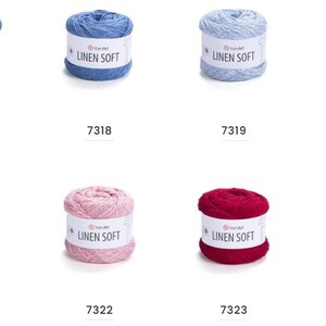 May include: Eight skeins of YarnArt Linen Soft yarn in various colors. The colors include shades of blue, gray, pink, red, and purple. Each skein has a white label with the text "LINEN SOFT" and a product number.