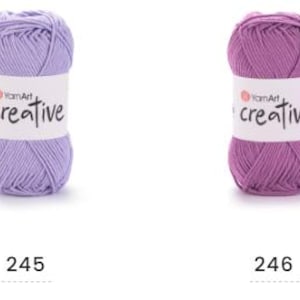 May include: Four balls of YarnArt Creative yarn in grey, lavender, purple, and turquoise. Each ball has a white label with the word "creative" in a script font. The numbers 244, 245, 246, and 247 are printed below each ball.