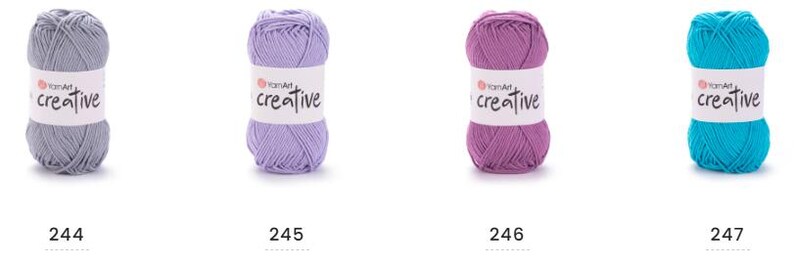May include: Four balls of YarnArt Creative yarn in grey, lavender, purple, and turquoise. Each ball has a white label with the word "creative" in a script font. The numbers 244, 245, 246, and 247 are printed below each ball.