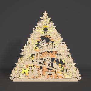 May include: A wooden Christmas tree decoration featuring a detailed design of a winter village scene. The ornament is illuminated with warm white lights, creating a festive glow.