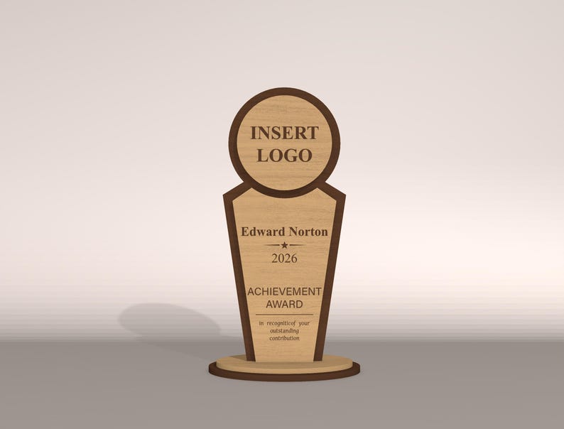 May include: A wooden achievement award with a light brown finish and dark brown trim. The award features a circular top with the text "INSERT LOGO", the name "Edward Norton", the year "2026", and the words "ACHIEVEMENT AWARD".