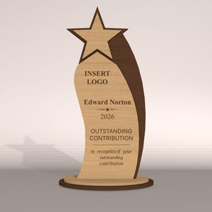 May include: A wooden award trophy with a star on top and a curved body. The trophy has the text "INSERT LOGO", "Edward Norton", "2026", and "OUTSTANDING CONTRIBUTION". The base is round.