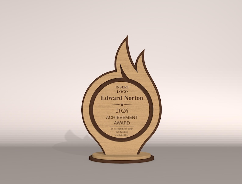 May include: A wooden achievement award with a flame-like design. The award features a circular center with the name "Edward Norton" and the year "2026". The text "ACHIEVEMENT AWARD" is also visible. The award is made of light and dark brown wood.