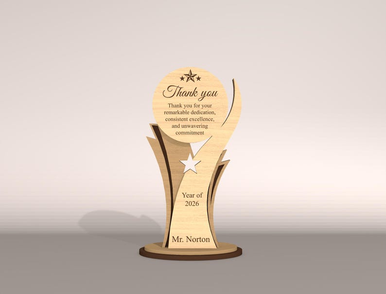 May include: A wooden trophy with a light brown finish. The trophy features the words "Thank you" and a message of appreciation. It includes the year "2026" and the name "Mr. Norton". The design incorporates star shapes and a decorative base.