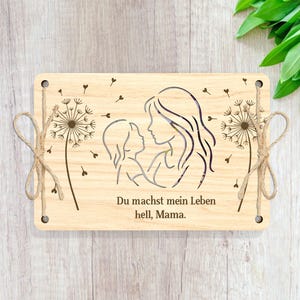 May include: Wooden sign with a cutout design of a mother and child, with dandelion accents. The text reads "Du machst mein Leben hell, Mama."