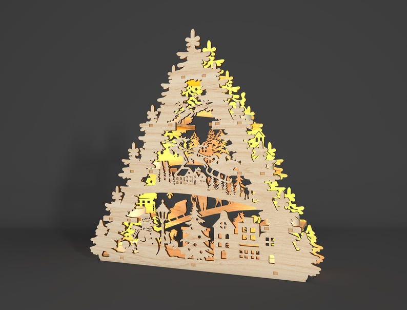May include: A wooden Christmas tree silhouette with intricate cutouts of houses, trees, and a sleigh with reindeer. The tree is illuminated from behind, creating a warm glow.