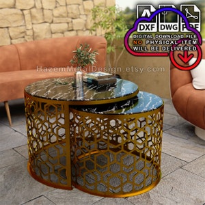 May include: A set of two gold metal nesting tables with a geometric honeycomb design. The tabletops are black marble with a white veining pattern. The tables are shown in an outdoor setting.