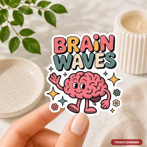 May include: A die-cut sticker featuring a cartoon pink brain character with arms and legs, waving one hand. The text "BRAIN WAVES" appears in large, colorful, retro-style bubble letters above the brain. Small star and flower icons surround the character.
